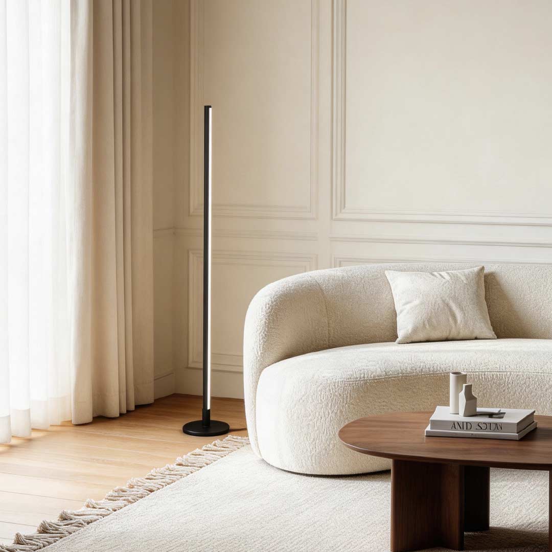 Modern living room lit by a slim linear floor lamp